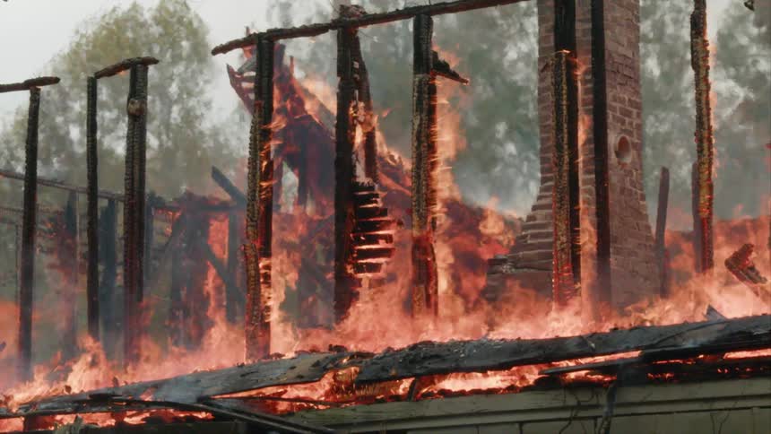 Chimney standing while a house frame is burning around it