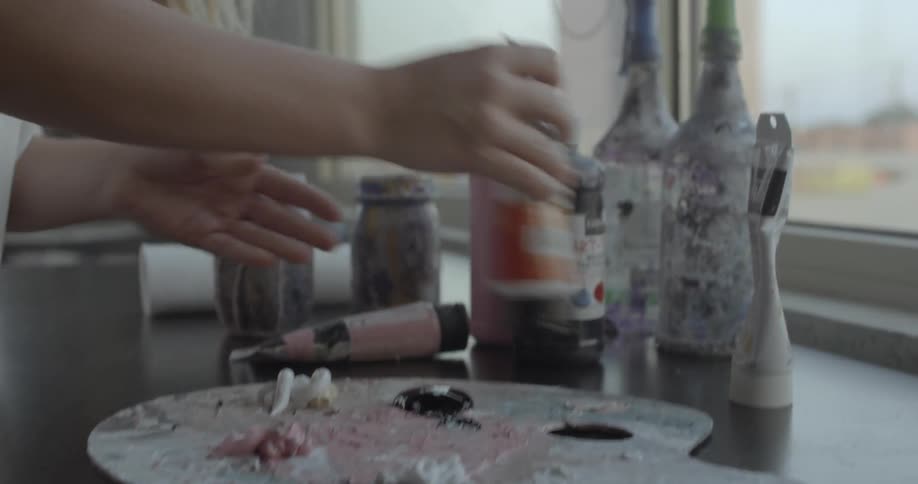 A painter mixes paint together