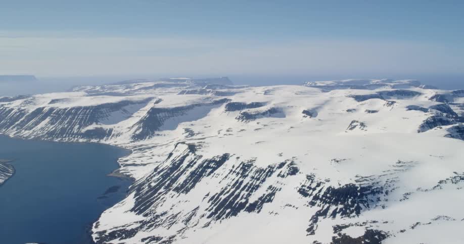 The mountain landscape is covered in ice and snow