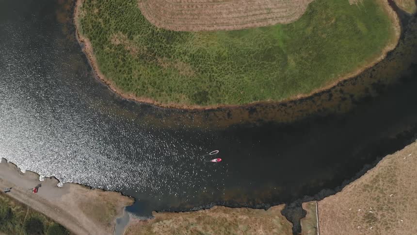 Boats navigate a river bend