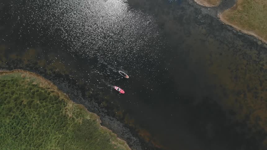 Kayaks traveling a river