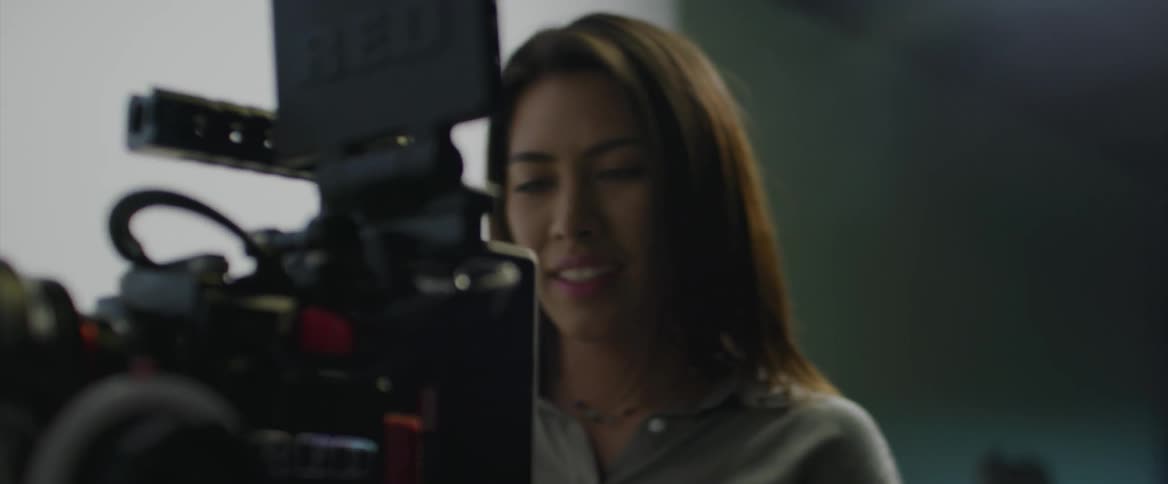 A woman is operating a camera