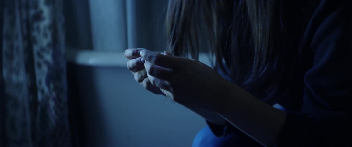 A woman is distraught and drops an object