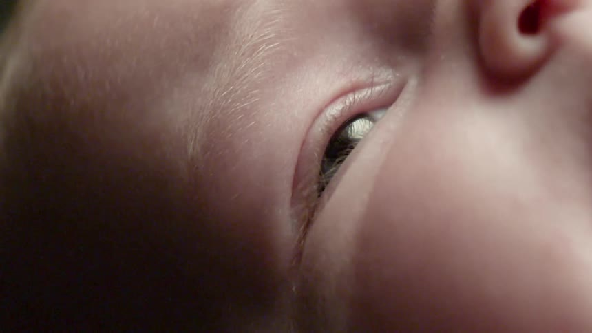 An infant opens its eyes wide