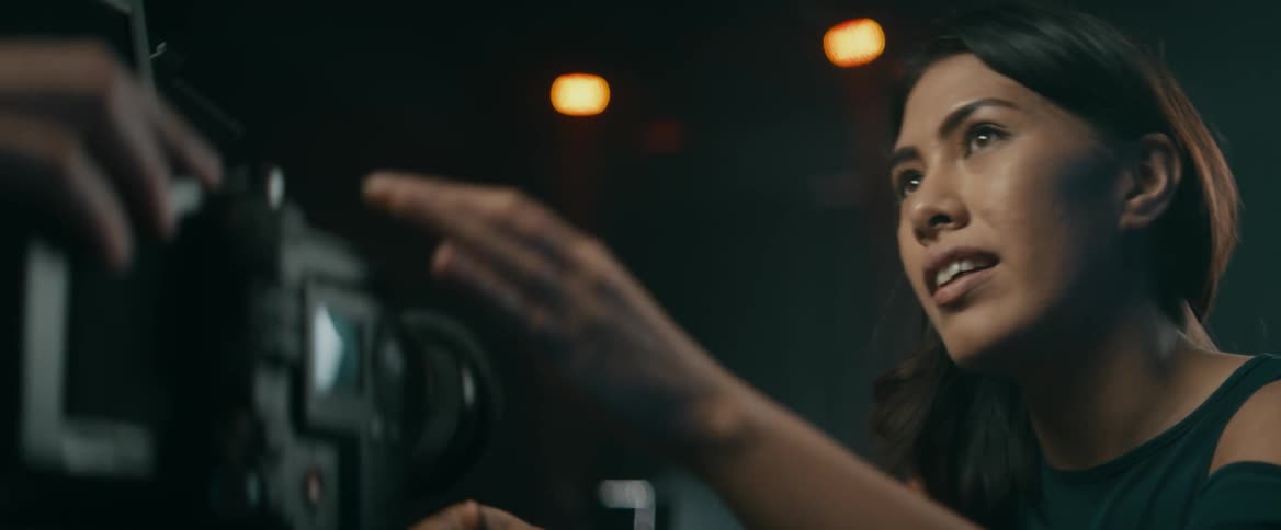 A woman assembles a camera