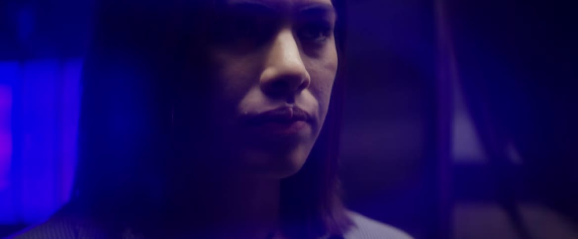 A woman stares into a mirror