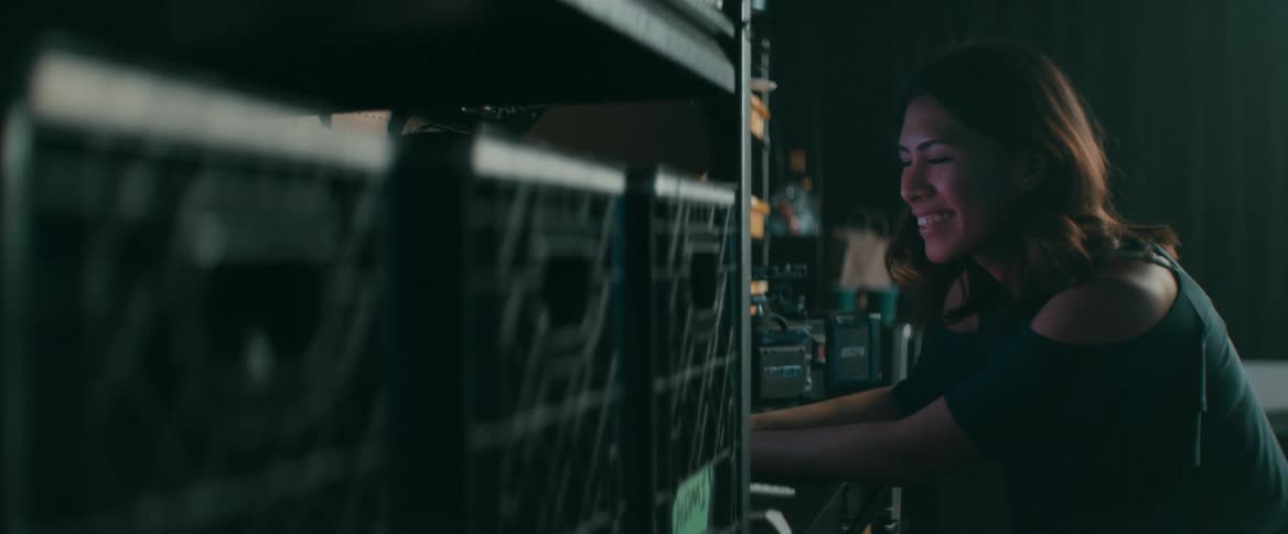 A woman sits near video filming equipment