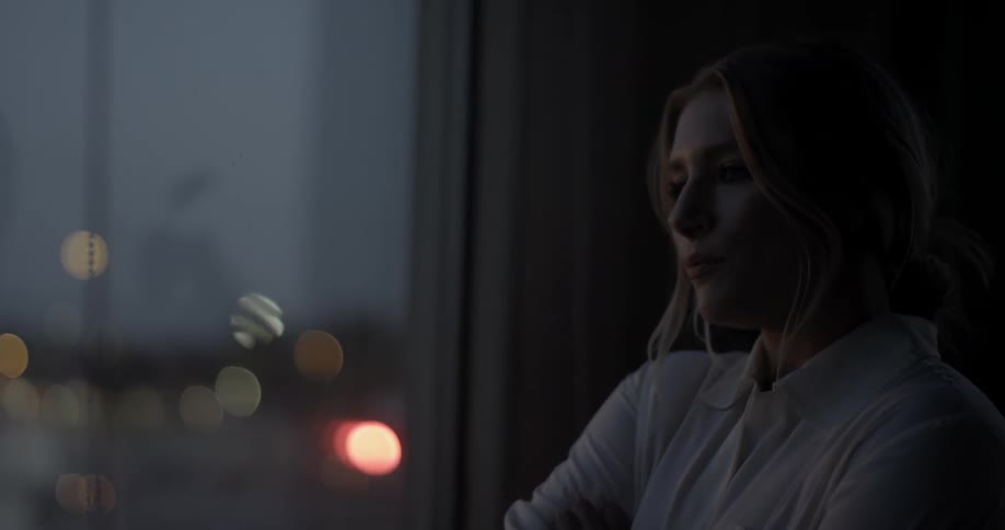 A woman looks out of a window