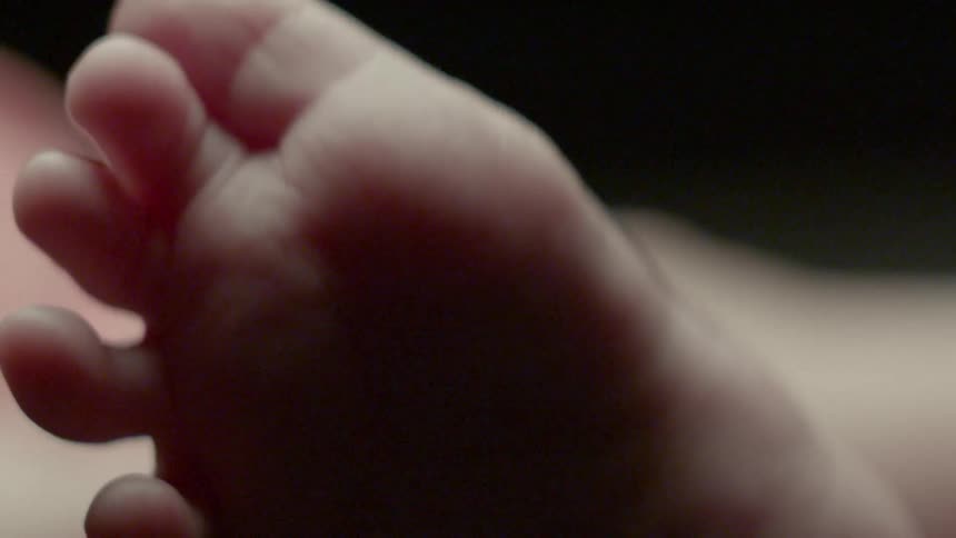 A baby wiggles his toes