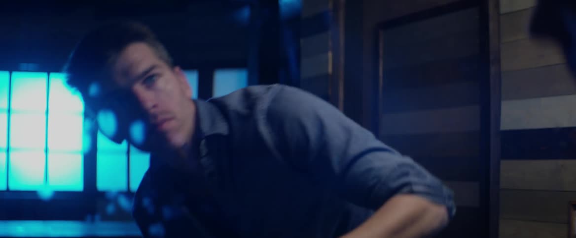 A man wipes a mirror clean