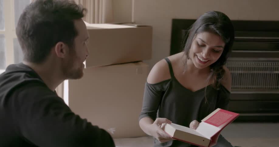 A man and woman unpack boxes