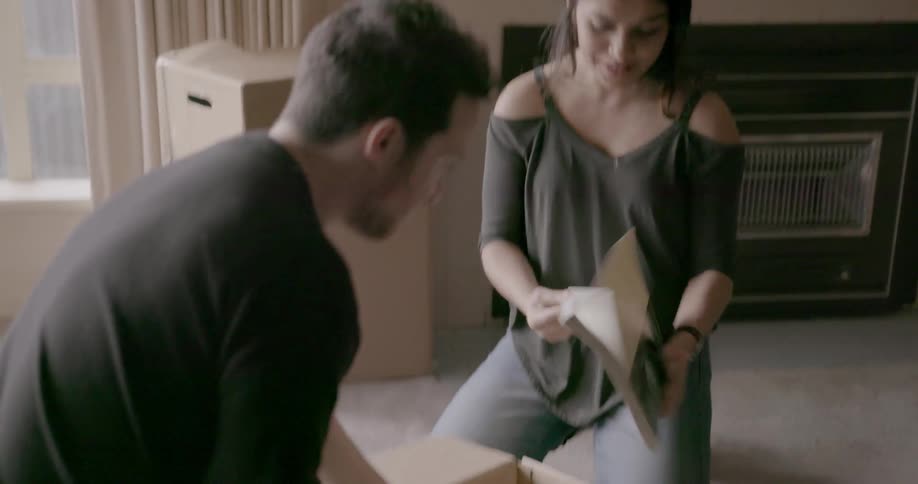 A man and woman unpack boxes