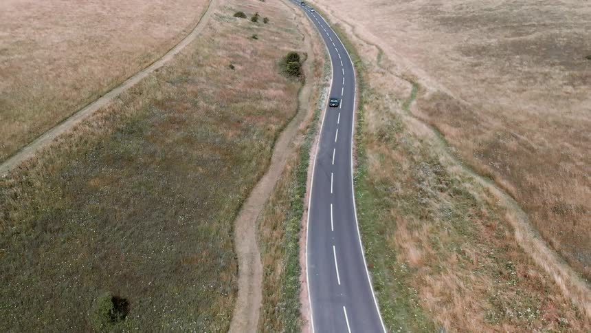 Car drives on a rural road