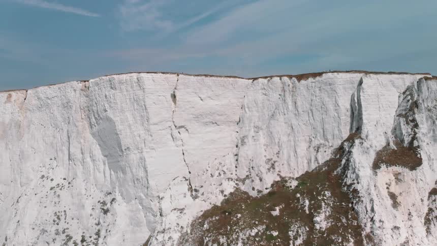 A snowy ridge near a blue sky
