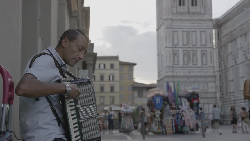 Man playing an accordion on a city street
