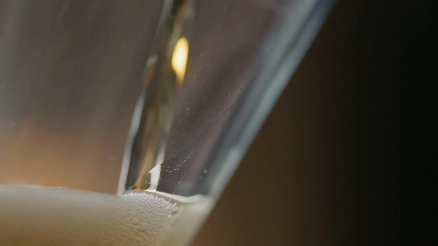 Beer is poured into a glass