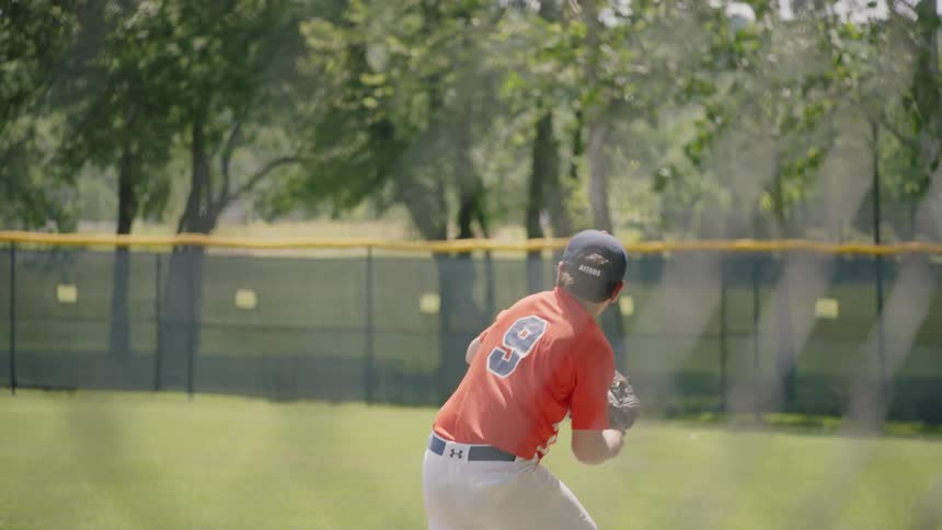 Boy catches a ball in the outfield