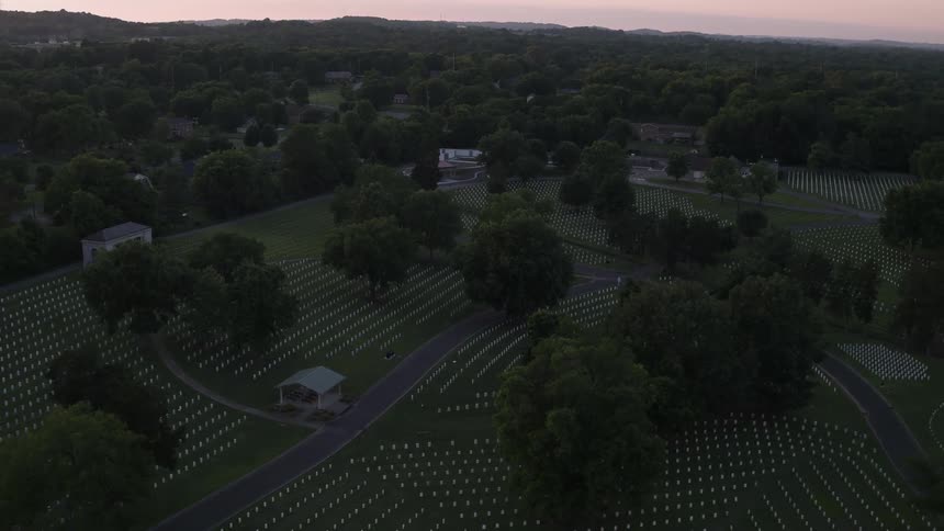 A cemetery is shown at dusk