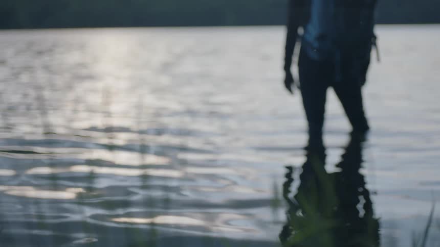A person stands in a lake