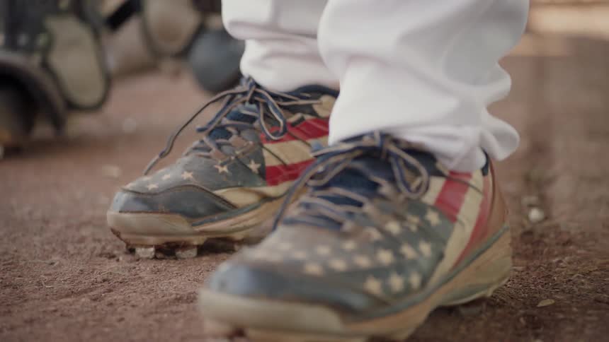 A man is wearing american flag shoes