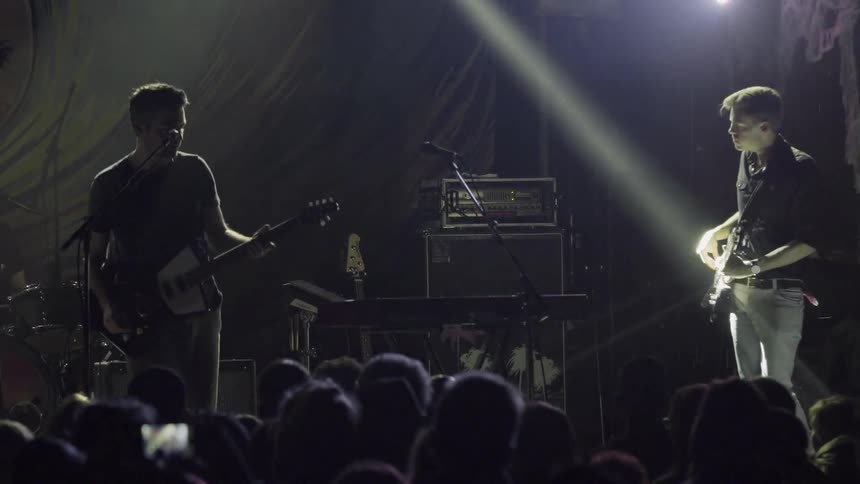 Band playing on stage while lights flash