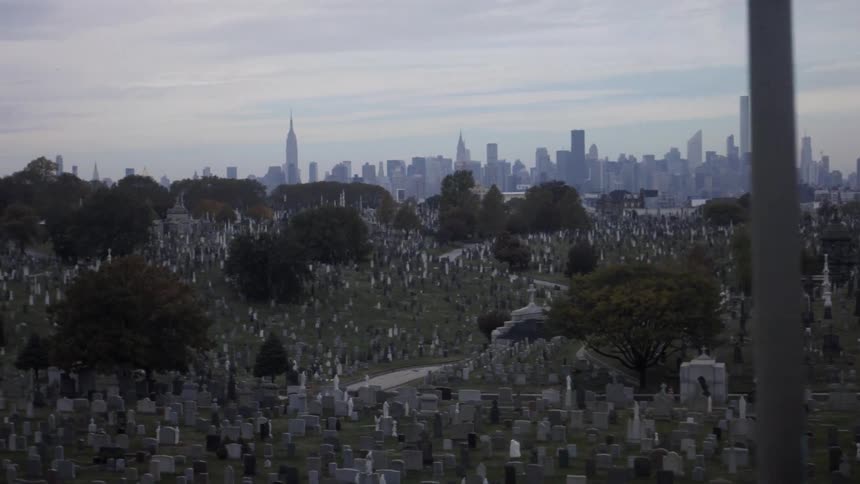 Headstones cover the grounds in a cemetery