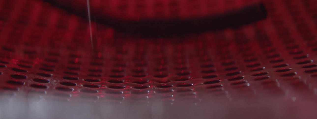 Water drips down onto a holey surface