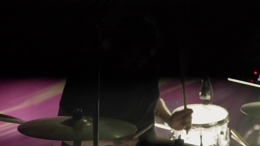 A drummer performs on stage