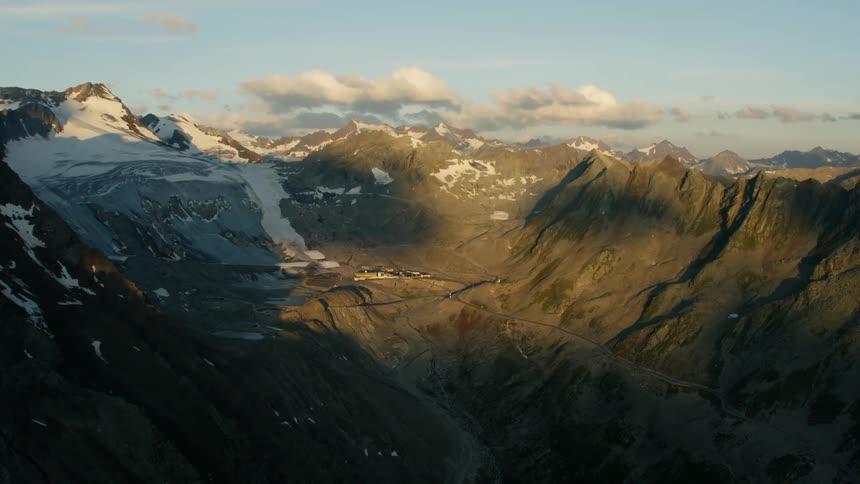 Mountain range partially covered in snow on cloudy day