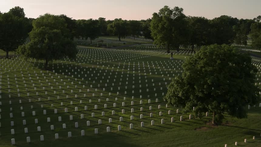Headstones are displayed symmetrically in a cemetery