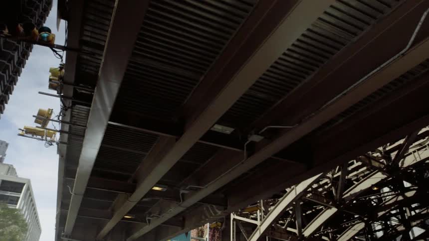A city bridge towers overhead