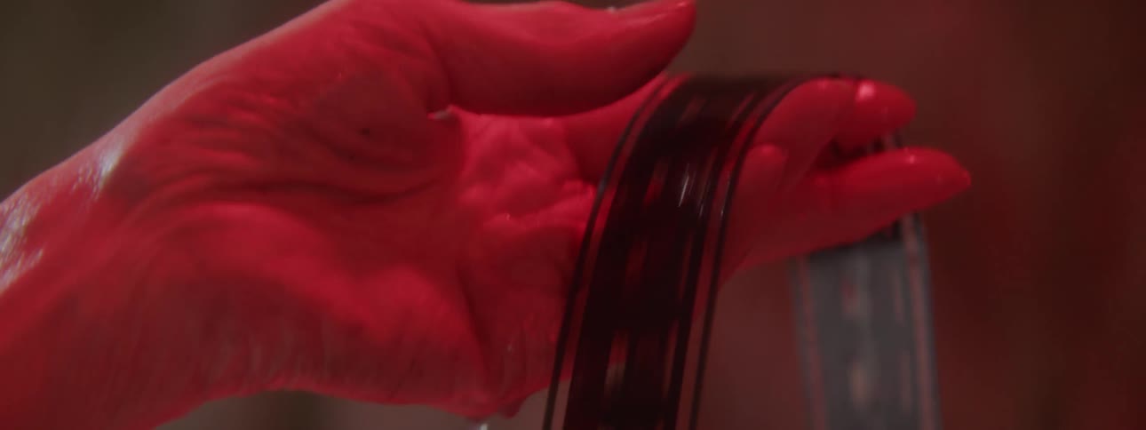 A woman scrolls through a roll of film