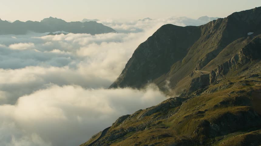 Clouds pass through the valley between mountains