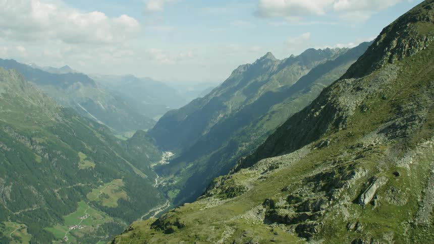 Lush green mountains with a valley in the distance