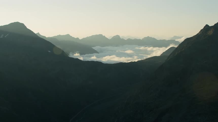 Thick clouds hanging below mountain peaks