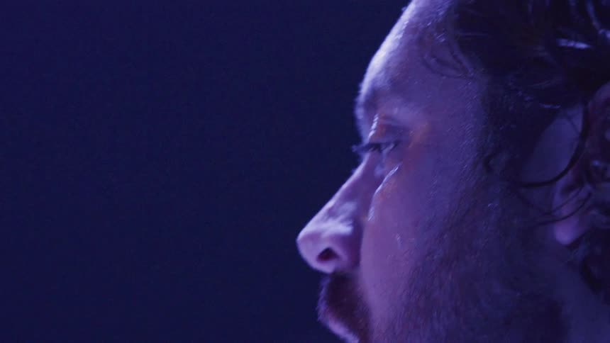 Someone is performing on stage and is sweating