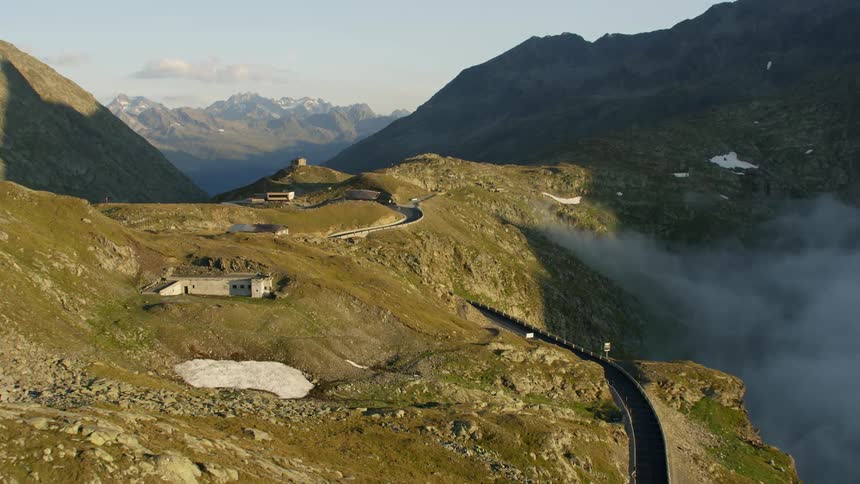 A winding road is etched on the side of a mountain