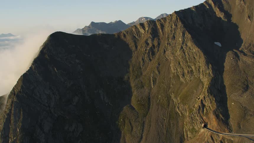 Clouds travel between mountains