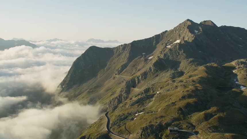 Mountain peak rises above the clouds