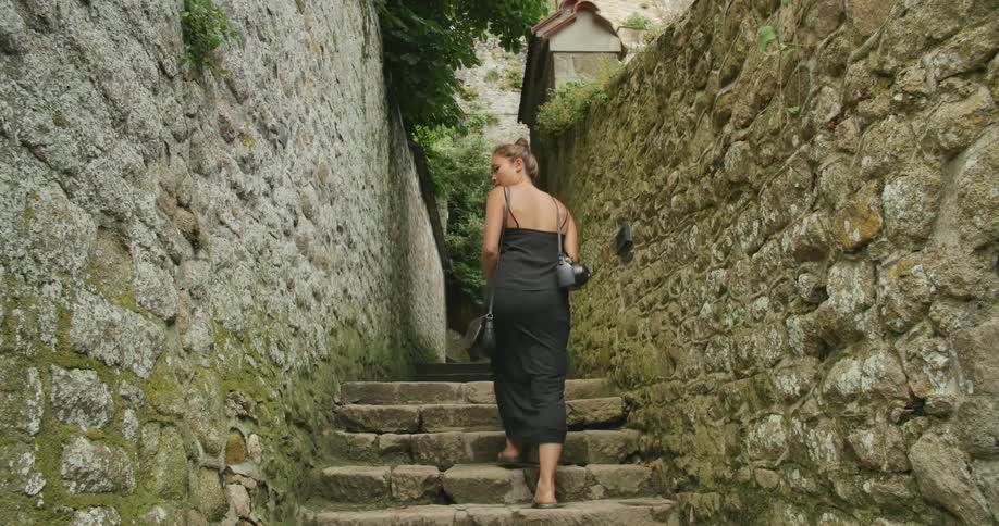 A woman walks up steps