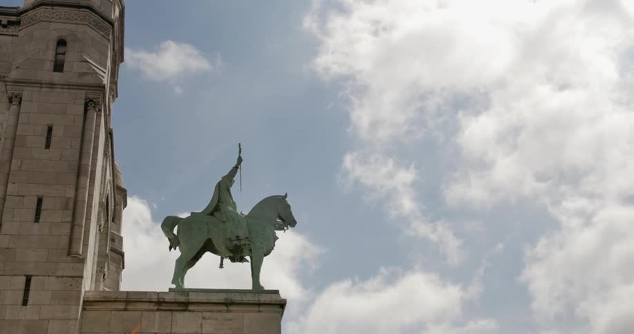 A statue of a man on a horse on a cloudy day