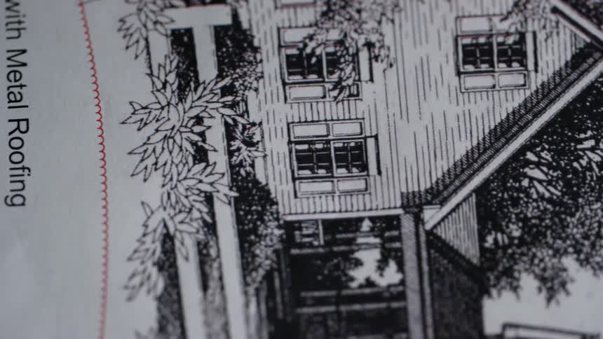 A sketch of a wooden house with metal roofing
