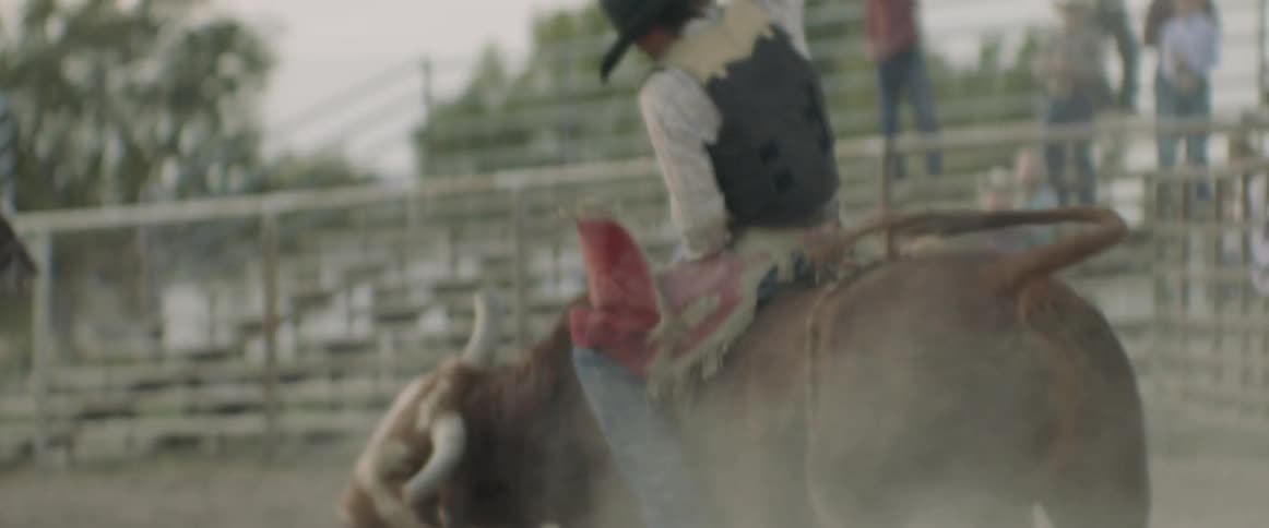 Man rides a bull on a ranch