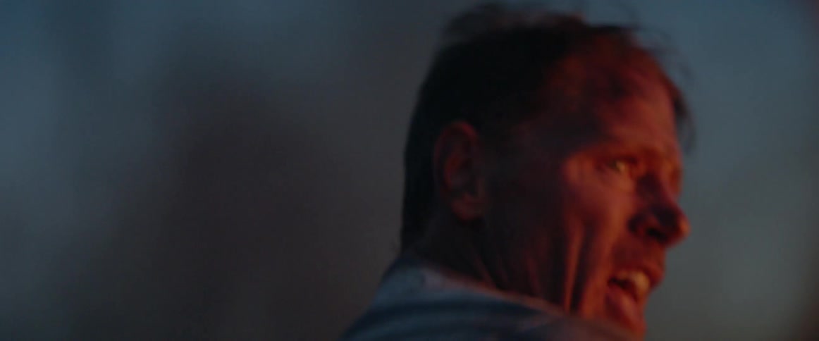 A man is yelling and moving around at sunset
