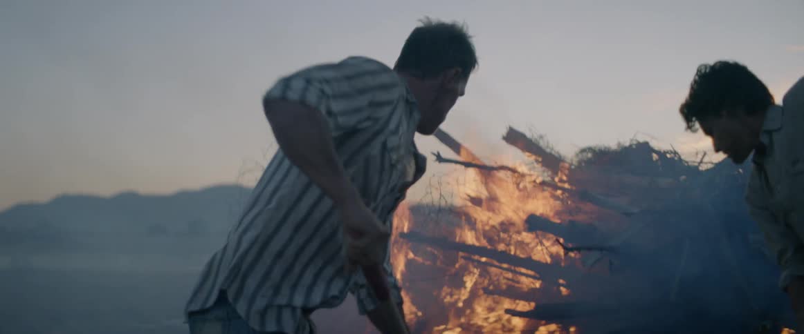 Two men attempt to extinguish a fire