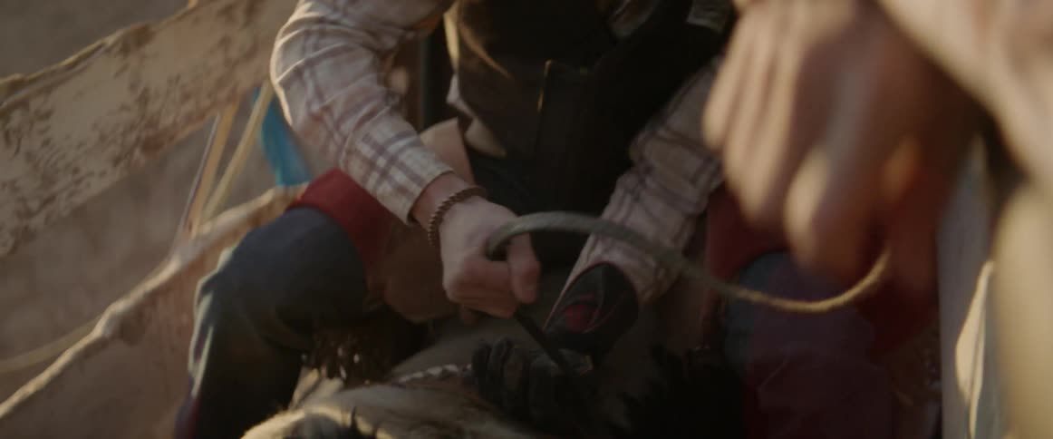 A cowboy ties his hand down before riding a bull