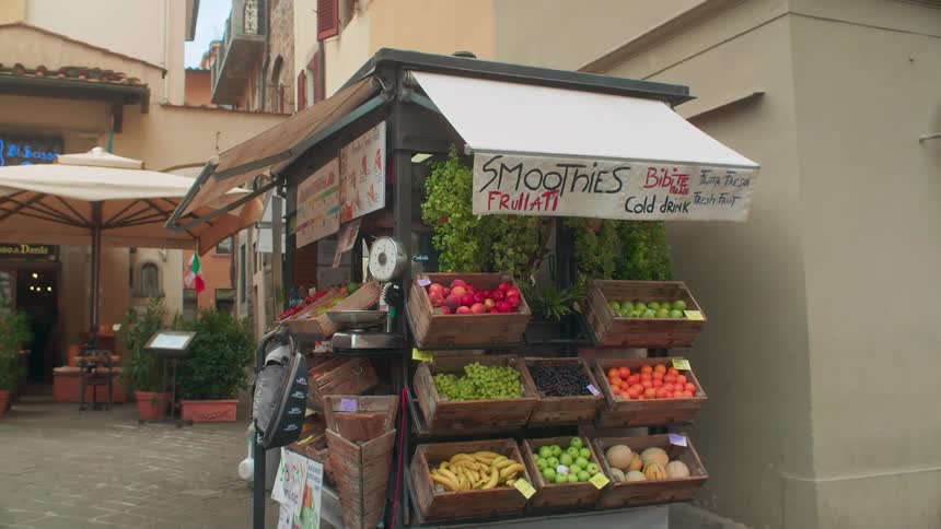 The stand has an assortment of fruits and serves smoothies