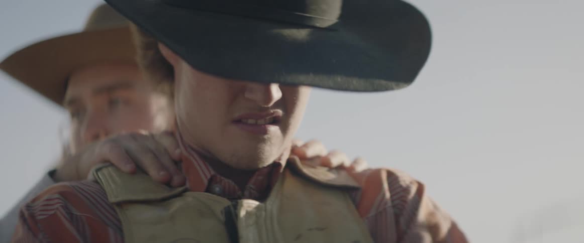 Cowboys work outside on a sunny day