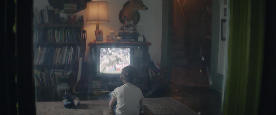 A young boy watching television at night, inspired by what he sees
