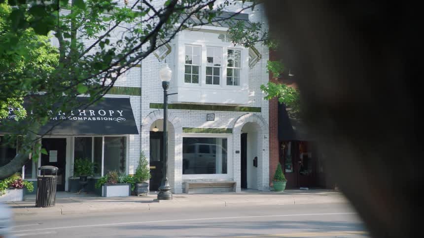 Cars drive down an urban street